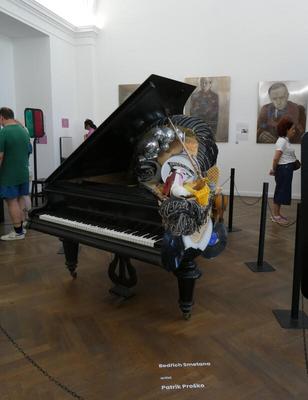 Piano that appears to have various objects strewn about on top of it