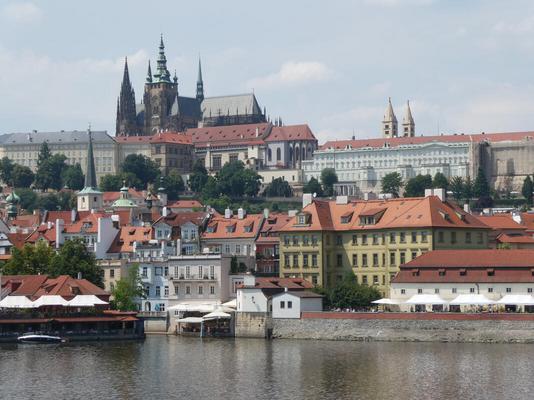 View from Charles Bridge. In background a cathedral. In foreground, the river