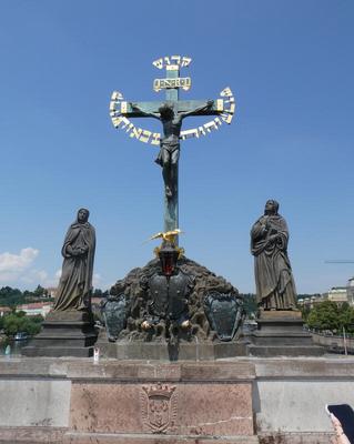 Crucifix with Hebrew lettering behind Jesus. The word Holy (in Hebrew) is above the cross.